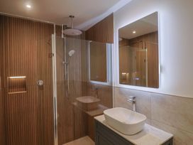 A bathroom featuring a shower and sink at The Fox Den in East Coker