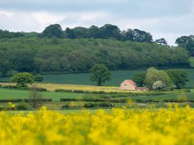 A house in a field surrounded by trees at The Fox Den in East Coker