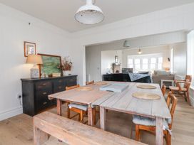 A dining room with a wooden table and chairs at 4 bed in Anglesey