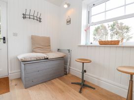 An entryway with a bench and side tables at 4 bed in Anglesey