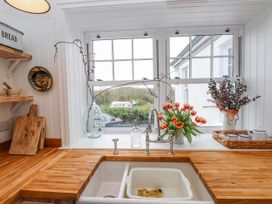 A kitchen with a sink and window at 4 bed in Anglesey