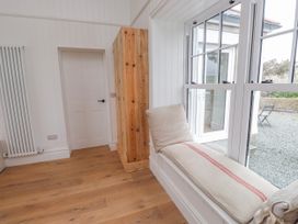 A room with a window seat and wooden cabinet at 4 bed in Anglesey