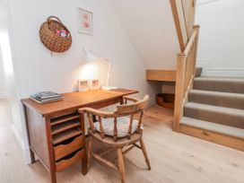A study area with a desk and a chair at 4 bed in Anglesey