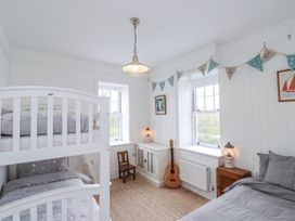 A bedroom with a bunk bed and a guitar at 4 bed in Anglesey