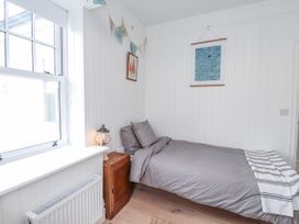 A bedroom with a bed and artwork at 4 bed in Anglesey