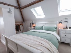 A bedroom with a bed and bedside table at 4 bed in Anglesey