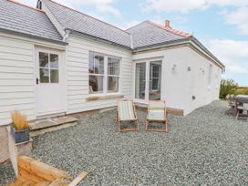 An outdoor area with chairs and a table at 4 bed in Anglesey