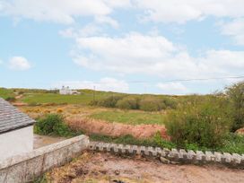 A field with a house and greenery at 4 bed in Anglesey