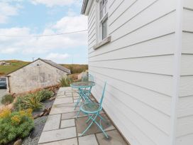 An outdoor seating area with a table and two chairs at 4 bed in Anglesey