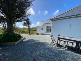 An outdoor area with a table and chairs at Arfryn Bull Bay