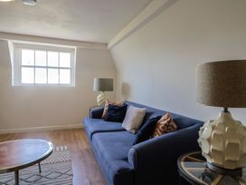 A living room with a sofa and lamp at FLAT 3 54a broad Street (2 bed sleeping 4) Lyme Regis