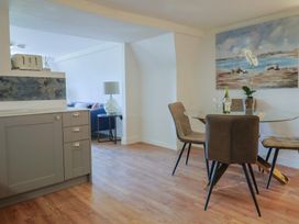 A kitchen with a dining area and a decorative painting at FLAT 3 54a broad Street (2 bed sleeping 4) Lyme Regis