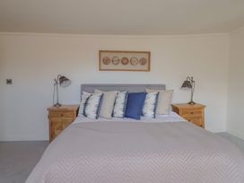 A bedroom with a bed and bedside tables at FLAT 3 54a broad Street (2 bed sleeping 4) Lyme Regis
