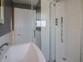 A bathroom with a bathtub and shower at FLAT 3 54a broad Street  (2 bed sleeping 4) Lyme Regis