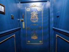 A decorative door with gold accents in a hallway at The Hollow in Holywell