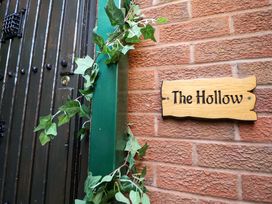 A door and wooden sign at The Hollow in Holywell