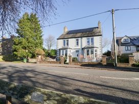A house with solar panels and trees at Rocklands in Shap