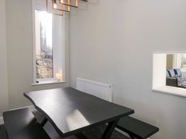 A dining room with a table and bench at Rocklands in Shap