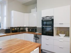 A kitchen with cabinets, appliances and a countertop at Rocklands in Shap