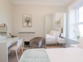 A bedroom with a bed and desk at Rocklands in Shap