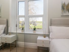 A bedroom with two nightstands and a window at Rocklands Shap