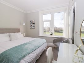 A bedroom with a bed and a chair at Rocklands in Shap