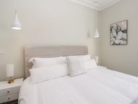 A bedroom with a bed and bedside lamp at Rocklands in Shap