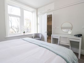 A bedroom with a bed, desk, chair, and window at Rocklands in Shap