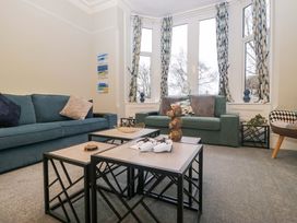 A living room with sofas and coffee tables at Rocklands in Shap