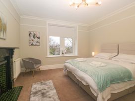 A bedroom with a bed and a chair at Rocklands in Shap