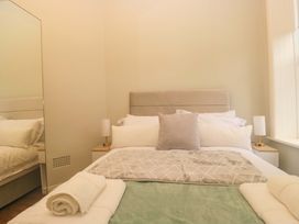 A bedroom with a bed and beside table at Rocklands in Shap