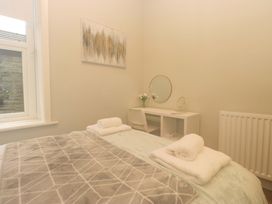 A bedroom with a bed and desk at Rocklands in Shap