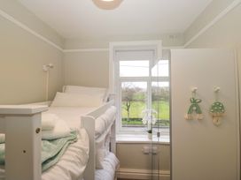 A bedroom with a bed and window at Rocklands in Shap