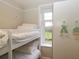 A bedroom with a bunk bed and a window at Rocklands in Shap