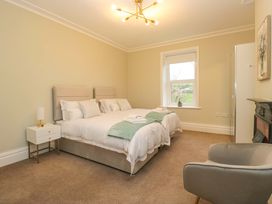A bedroom with a bed and nightstand at Rocklands in Shap