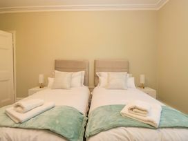 A bedroom with two beds and towels at Rocklands in Shap