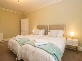 A bedroom with two beds and a nightstand at Rocklands in Shap