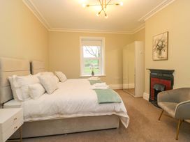 A bedroom with a bed and a window at Rocklands in Shap