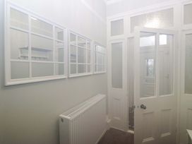 A hallway with mirrors and a radiator at Rocklands in Shap