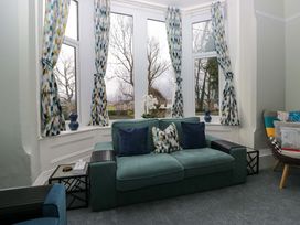A living room with a sofa and curtains at Rocklands in Shap