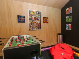 A game room with a foosball table and wall art at Rocklands in Shap