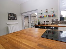 A kitchen with appliances and a table at Rocklands in Shap