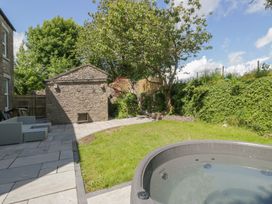 A garden with a hot tub and storage shed at Rocklands in Shap
