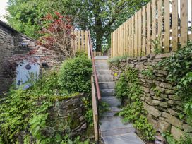 Stairs leading up to a wooden fence and garden at Rocklands in Shap