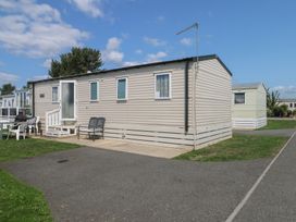 A mobile home with steps and seating area at Tower View Number 34 Pevensey