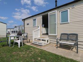 A caravan with steps and outdoor furniture at Tower View Number 34 in Pevensey
