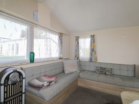 A snug with a sofa and window at Tower View Number 34 Pevensey