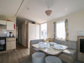 A kitchen with a dining area and cabinets at Tower View Number 34 Pevensey