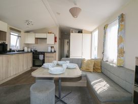A kitchen with a dining area and appliances at Tower View Number 34 Pevensey