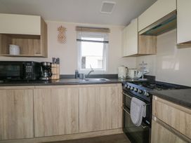 A kitchen with appliances including a microwave and coffee maker at Tower View Number 34 in Pevensey